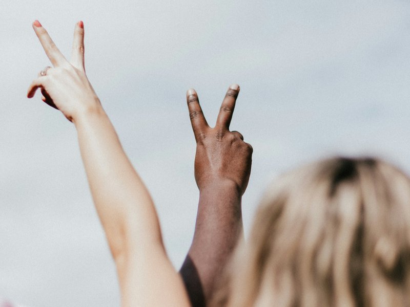 2 person doing heart hand gesture