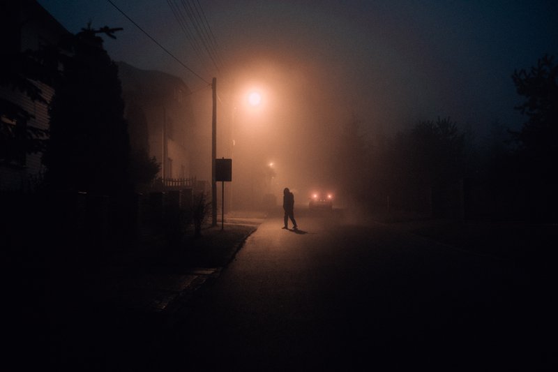 person walking in the snow at night