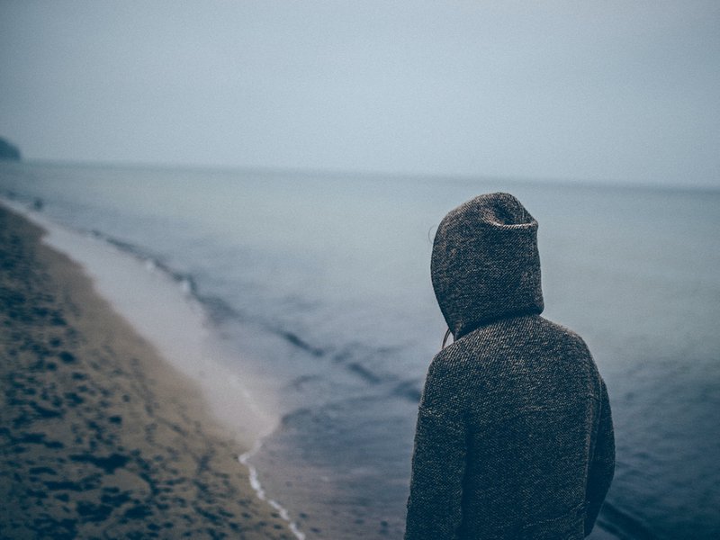 person standing beside seashore