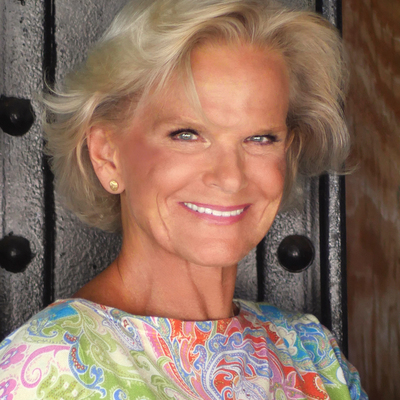A woman with blonde hair smiling at the camera.