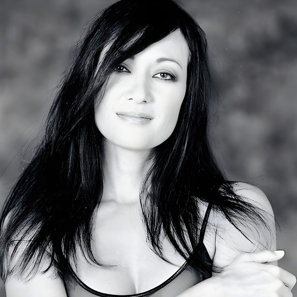 A portrait of a woman with dark hair looking toward the camera.